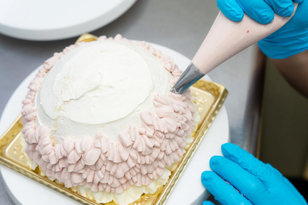 Hands shaping a cake at Time for Tea